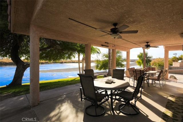 view of patio / terrace with ceiling fan and a water view