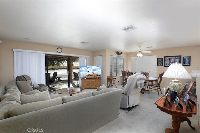 carpeted living room featuring ceiling fan