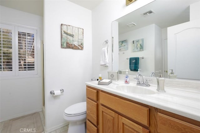 bathroom with tile patterned floors, toilet, and vanity