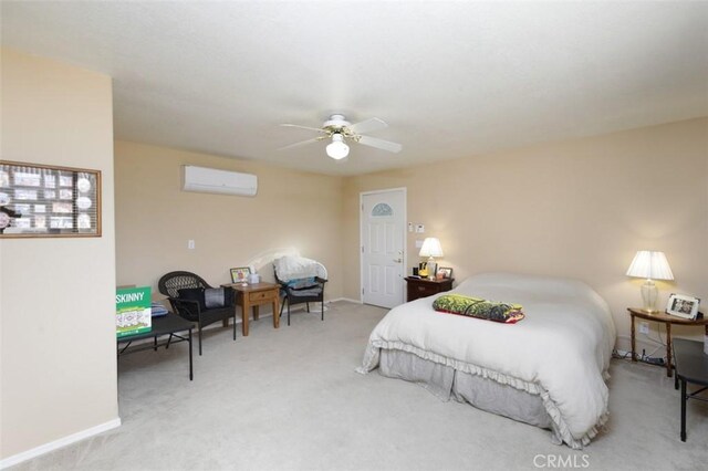 bedroom with ceiling fan, carpet floors, and a wall mounted air conditioner