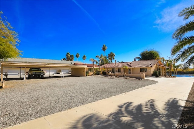 view of front of house with a water view and a carport