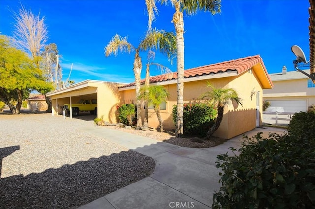 view of front of property with a garage and a carport