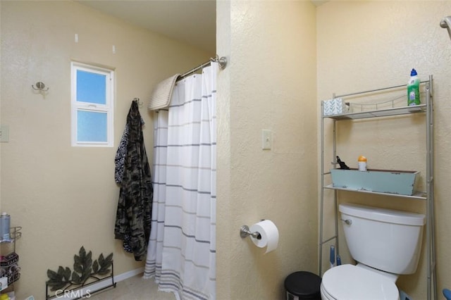 bathroom featuring toilet and a shower with curtain