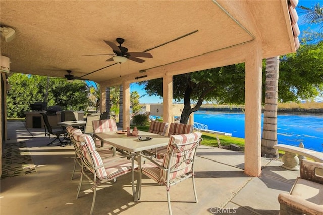 view of patio / terrace featuring a water view and ceiling fan