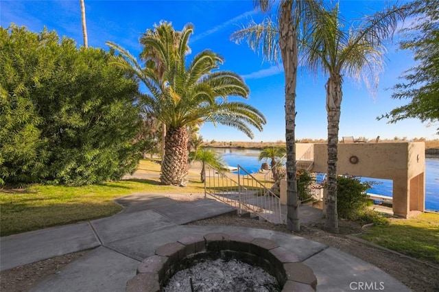 view of patio / terrace featuring a water view and an outdoor fire pit