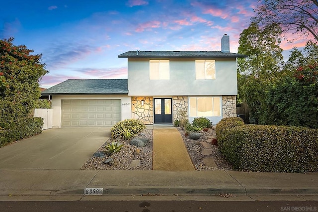 view of front of home with french doors and a garage