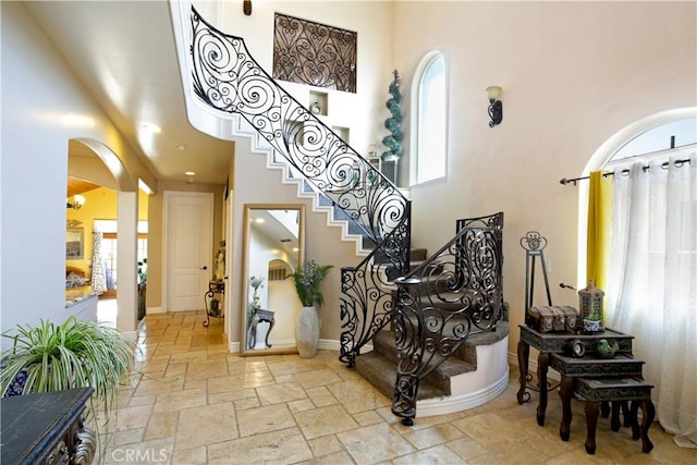 foyer entrance featuring a healthy amount of sunlight and a high ceiling