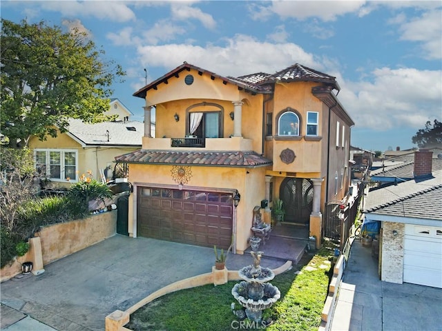 mediterranean / spanish home featuring a garage and a balcony