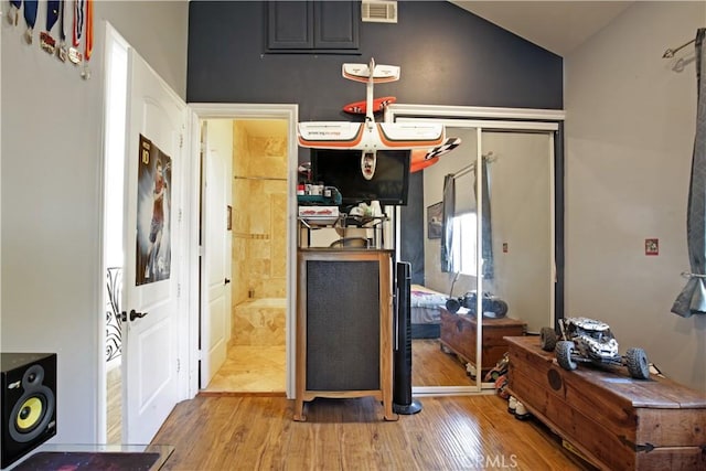 interior space with light hardwood / wood-style flooring and lofted ceiling