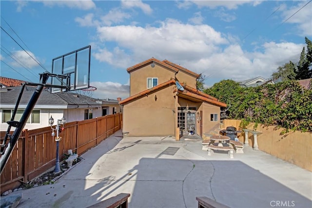 rear view of property with a fire pit