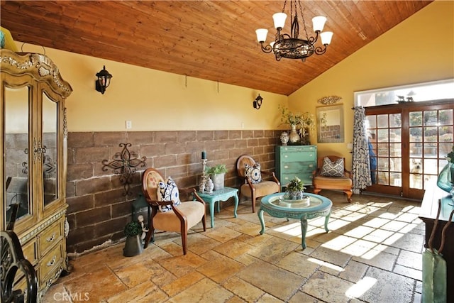 living area with high vaulted ceiling, french doors, wood ceiling, and a notable chandelier