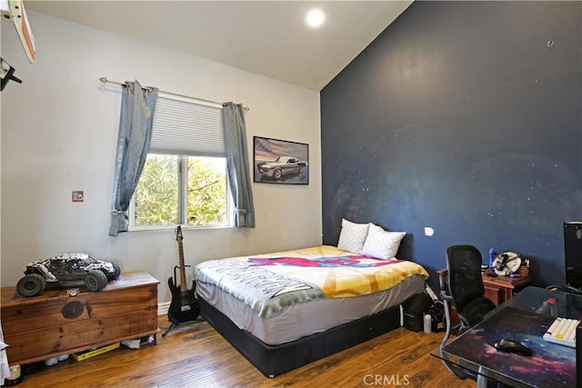 bedroom featuring lofted ceiling and wood-type flooring