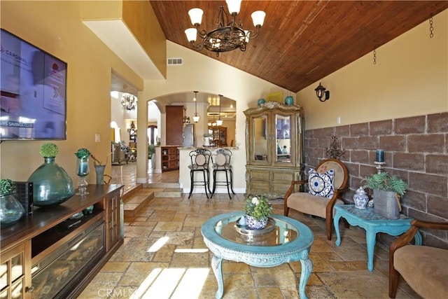 living room featuring vaulted ceiling, an inviting chandelier, and wood ceiling