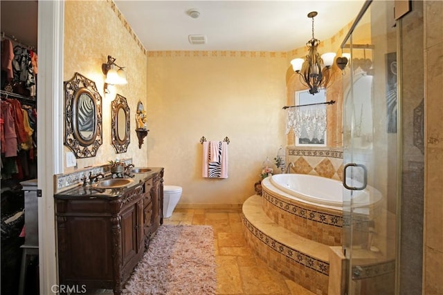 full bathroom featuring separate shower and tub, vanity, a notable chandelier, and toilet