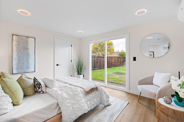 bedroom featuring access to exterior and light hardwood / wood-style floors