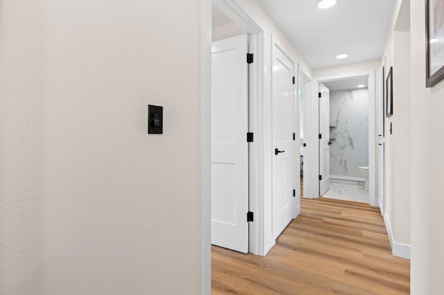 corridor with light hardwood / wood-style flooring