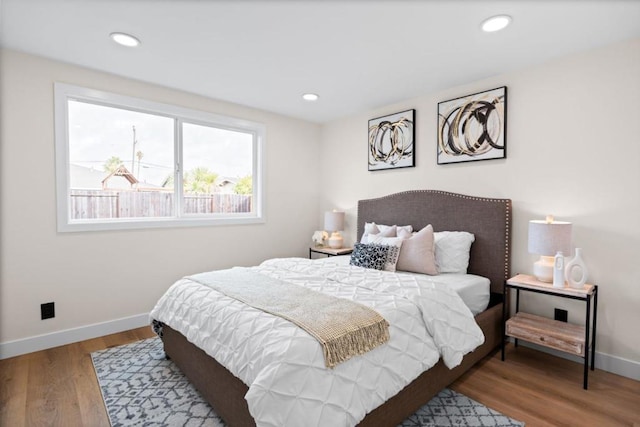 bedroom with hardwood / wood-style flooring