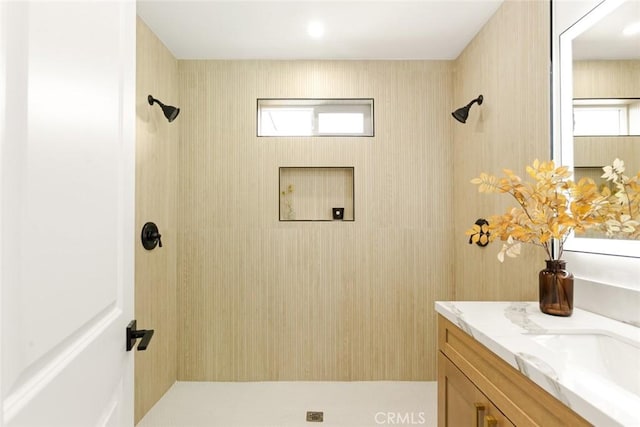 bathroom with vanity and a shower