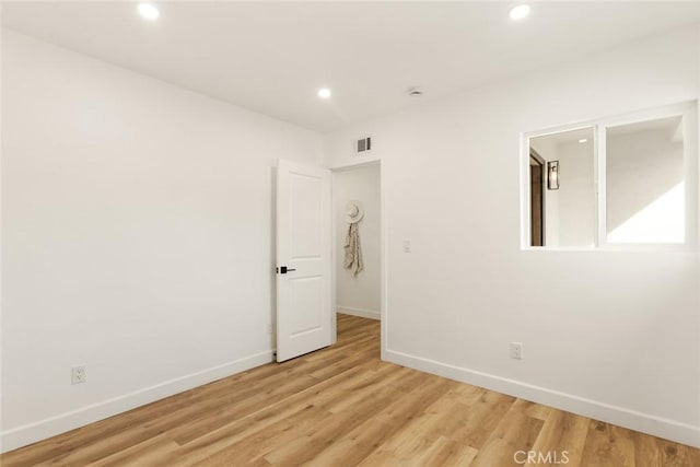 empty room with light hardwood / wood-style flooring