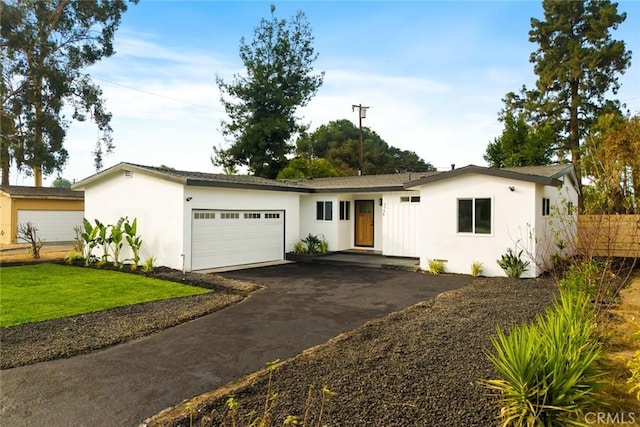 ranch-style home with a garage and a front yard