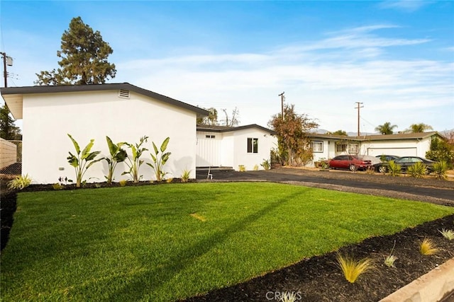 exterior space featuring a garage and a front yard