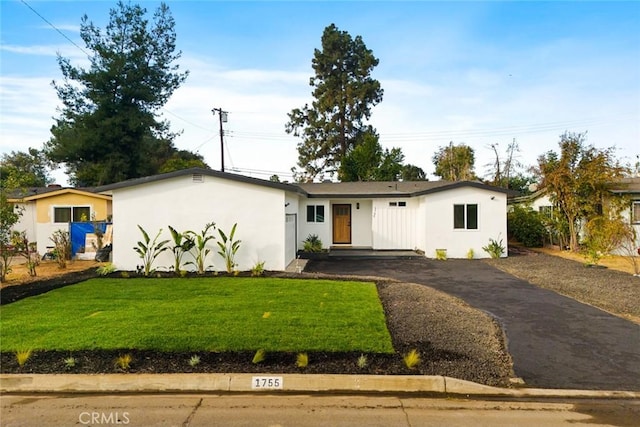 ranch-style house with a front lawn