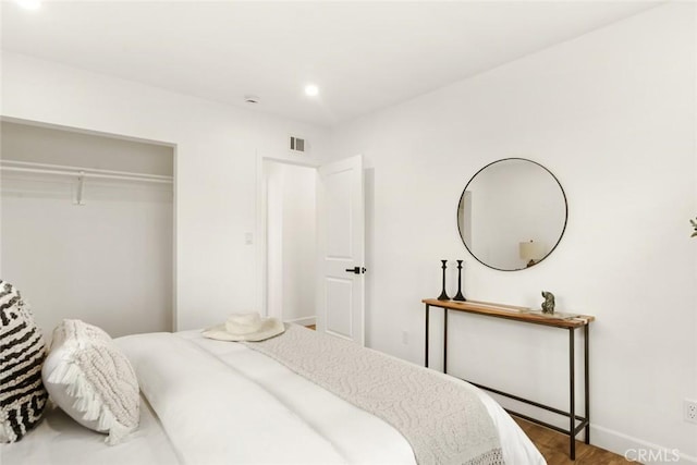 bedroom with a closet and wood-type flooring