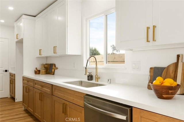 kitchen with sink, white cabinets, dishwasher, and plenty of natural light