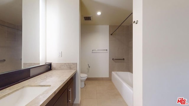 full bathroom featuring toilet, vanity, tile patterned flooring, and tiled shower / bath combo