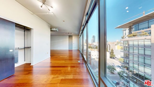 hallway with hardwood / wood-style floors