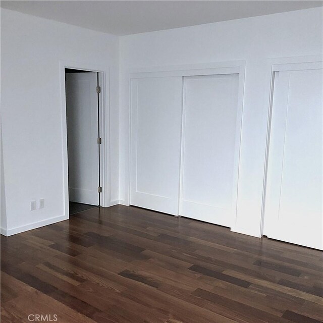 1200 Opal St Unit 22, Redondo Beach, CA 90277 - unfurnished bedroom with dark wood-style floors and multiple closets