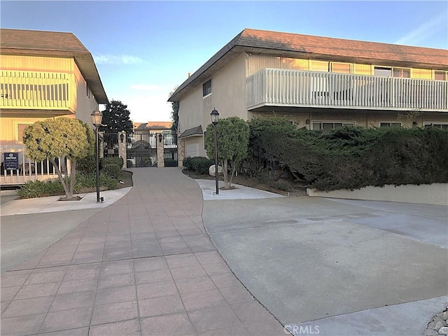 exterior space with street lighting and a gate