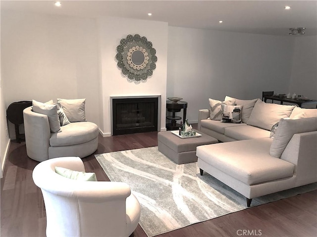 living area featuring dark wood finished floors, recessed lighting, a fireplace, and baseboards