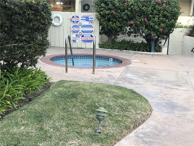 view of pool with a hot tub