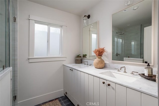 bathroom with tile patterned flooring, a shower with shower door, and vanity