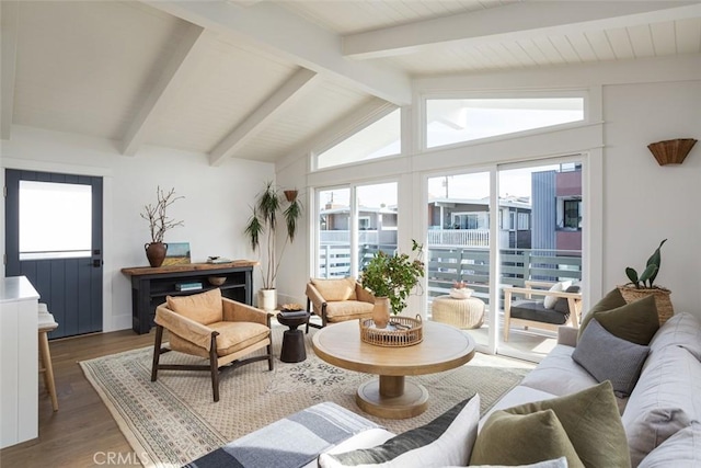 living room with lofted ceiling with beams and hardwood / wood-style floors