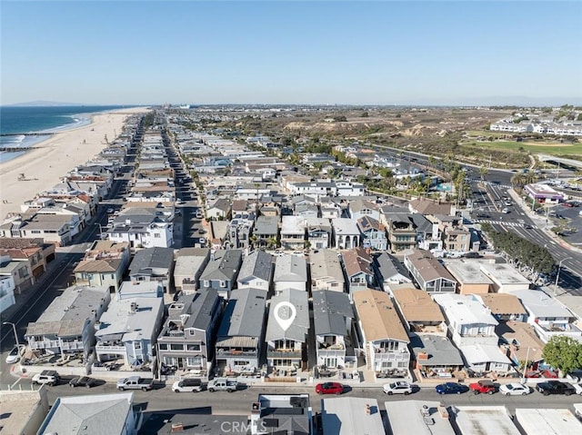 aerial view with a water view and a view of the beach