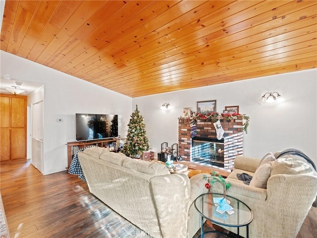 living room with lofted ceiling, a brick fireplace, wood ceiling, and wood-type flooring