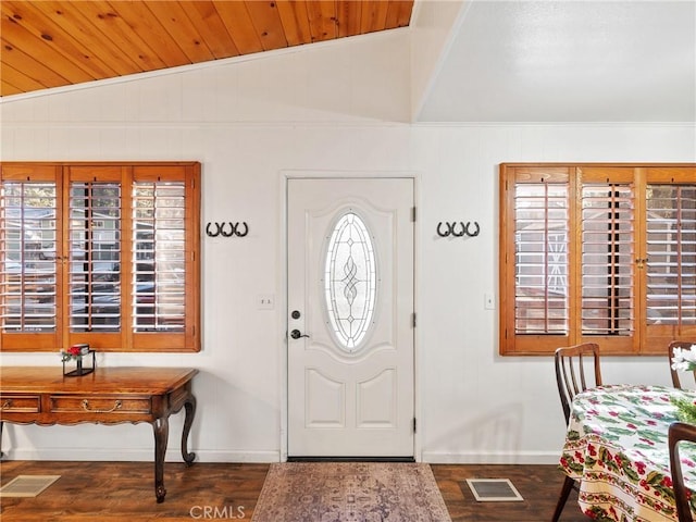 foyer featuring vaulted ceiling and dark wood-type flooring