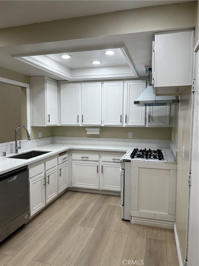 kitchen featuring white cabinets, light countertops, dishwasher, and a sink