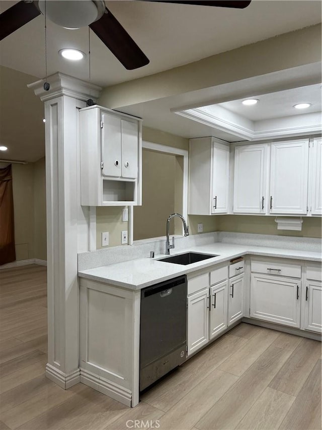 kitchen with light countertops, a ceiling fan, white cabinetry, a sink, and dishwashing machine