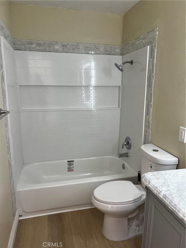 full bathroom with toilet, vanity, wood-type flooring, and tiled shower / bath combo