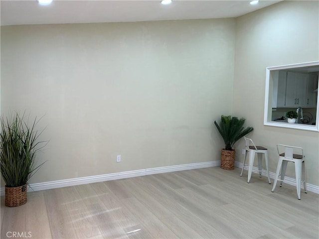 empty room featuring recessed lighting, light wood-style flooring, and baseboards