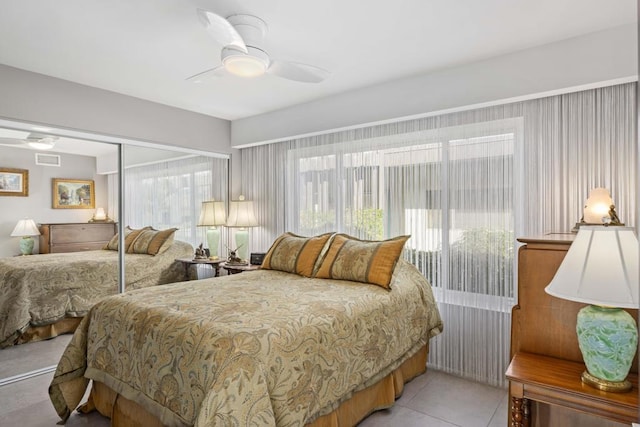 bedroom with ceiling fan, a closet, and light tile patterned flooring