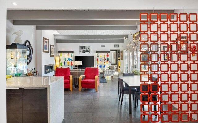 dining space featuring beam ceiling