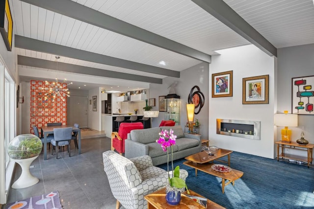 living room with beam ceiling, a fireplace, and a notable chandelier