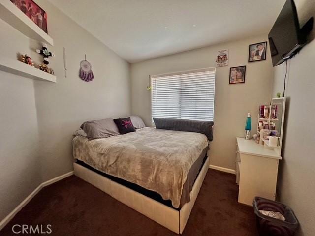 bedroom featuring dark colored carpet