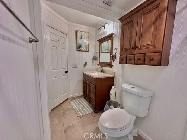 bathroom featuring toilet, vanity, and tile patterned flooring