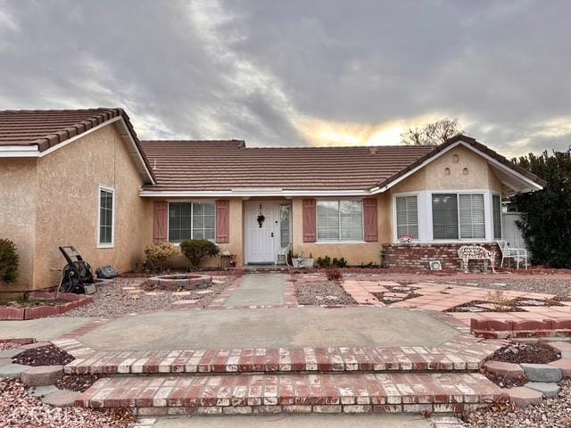 ranch-style home with a patio