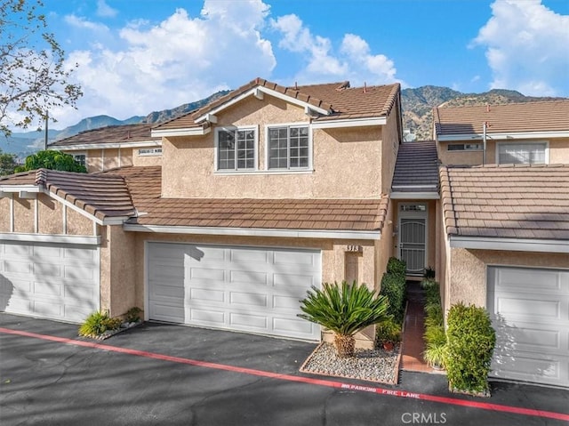 front of property featuring a mountain view and a garage